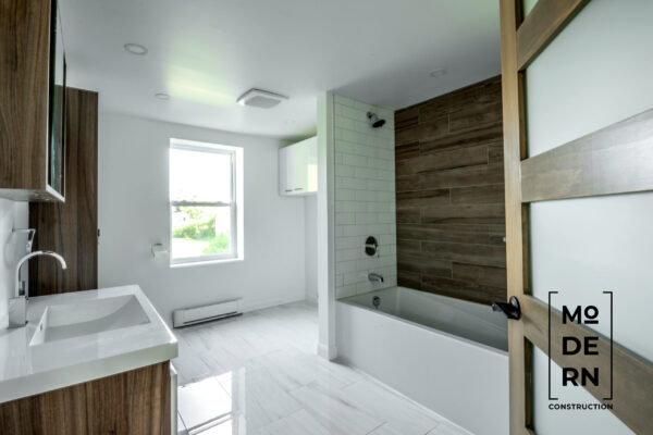 Salle de bains moderne avec baignoire et bois.